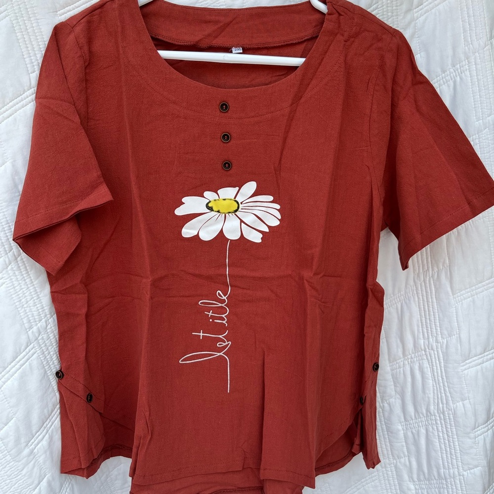 Burnt orange blouse saying “let it be”